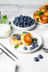 syrniki . Appetizing cheesecakes with sauce and blueberries