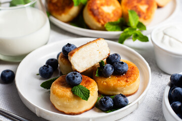 syrniki . Appetizing cheesecakes with sauce and blueberries