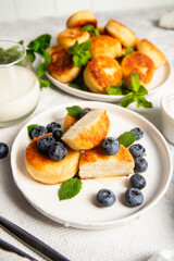 syrniki . Appetizing cheesecakes with sauce and blueberries