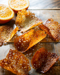 French tuile cookies. Classic butter and orange oval-shaped tuile cookies, a French recipe.