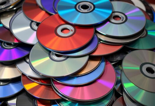 A messy stack of used CDs and DVDs, various colors and conditions,  disorder,  vintage