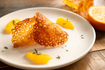French tuile cookies. Classic butter and orange oval-shaped tuile cookies, a French recipe.