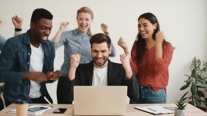 Excited diverse business team celebrating a major success in the office. - Powered by Adobe