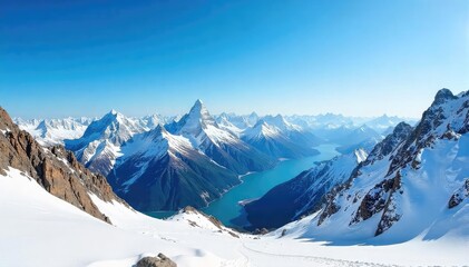 Obraz premium Breathtaking panoramic view of snow-capped mountain peaks, rugged terrain, and a vast, clear blue sky Perfect for adventure, travel, and nature projects , terrain, beautiful