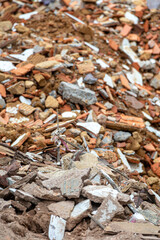 A chaotic pile of rubble and demolition debris, featuring concrete and brick textures. Rubble and debris from old construction in various sizes.