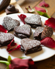 Heart-shaped dark chocolate cookies filled with chocolate and coffee cream. A recipe for lovers on Valentine's Day.