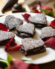 Heart-shaped dark chocolate cookies filled with chocolate and coffee cream. A recipe for lovers on Valentine's Day.