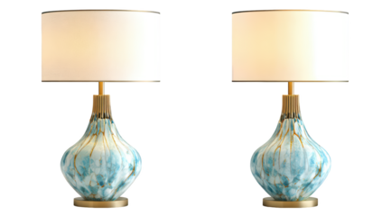 Two elegant turquoise lamps with gold accents and white shades, glowing warmly