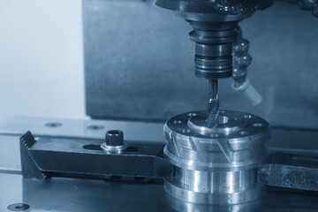 The tapping cycle operation the metal parts on CNC milling machine by spiral tapping tool in the blue tone scene.