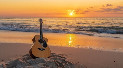 Acoustic guitar on a sandy beach at sunrise