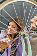Joyful summer moment captured with a young woman enjoying a bike ride in the city