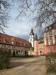 Obraz premium Historic German Castle Courtyard with Half-Timbered Buildings and Tower
