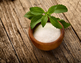 Stevia rebaudiana, sweet leaf sugar substitute isolated in wooden bowl on wooden background