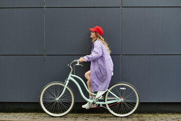 Young woman riding a bicycle in a vibrant summer outfit enjoying the sunny day