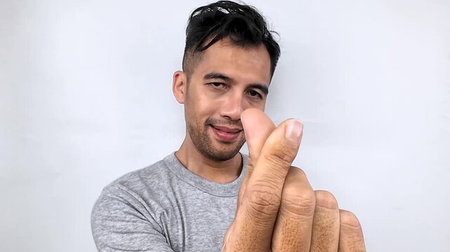Smiling Man Posing Against White Background.