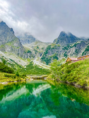 Scenic view of mountain lake and hut (Chata pri zelenom plese) in High Tatras, Slovakia. Zelene...