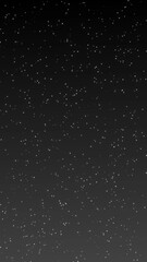 Shiny glitter particles on dark gray gradient background 