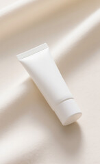 A Clean White Tube of Lotion or Cream on a Soft Beige Fabric Surface with Sunlight Streaks