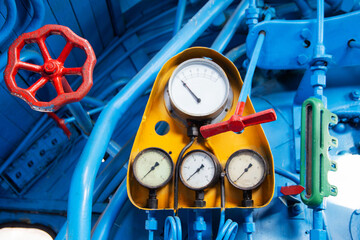 Control panel of an old steam locomotive inside with gauges and pressure gauges, close-up
