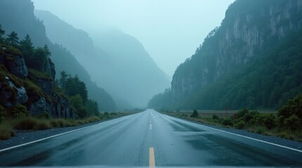 Fototapeta premium Empty Wet Road Leading to Misty Green Mountain Valley