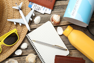 Time for summer vacation. Stationery, passport, flight tickets, toy plane, world map, purse and...