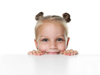 Curious little girl peeking over table against white background