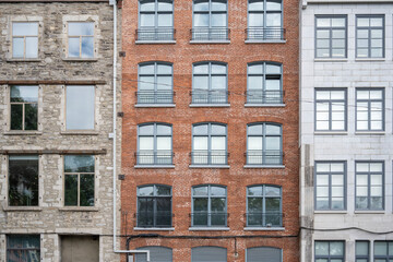 Facade of a building characterized by several architectural elements in Old Montreal.