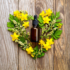 Amber glass bottle next to glass pipette dropper in the shape of a heart formed by natural flowers such as Flower Remedy Bach Agrimony (Agrimonia eupatoria), flower remedy Bach, background rustic