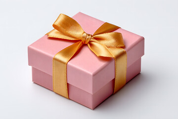 Obraz premium Small pastel pink gift box with satin golden ribbon. Perfect for romantic occasions, birthday packaging, or feminine product branding.