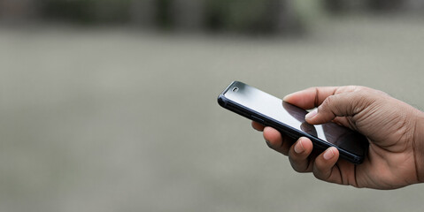 Man hands holding and touching a smartphone isolated on transparent background