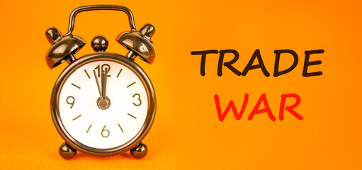 Trade war symbol. Concept word Trade war on beautiful orange paper. Beautiful black alarm clock. Beautiful orange paper background. Business trade war concept. Copy space.