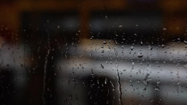 Rain drops on a window of moving train