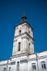 White Monastery Facade Against Clear Blue Sky