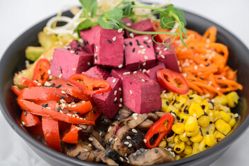 bibimbap with cheese and mushrooms with avocado, corn, pepper and sprouts in a plate macro