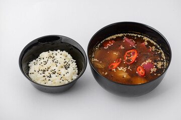 kimchi soup with rice in a separate plate on a white background