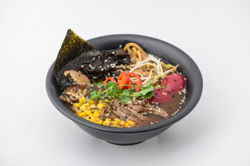 Korean soup with meat and seaweed in a black plate