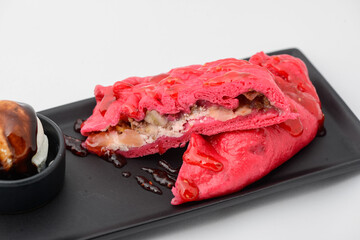 Korean dish pink flatbread with meat on a white background macro photo