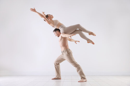 Couple of professional dancers training in studio