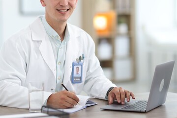 Telemedicine. Doctor having video call with patient via laptop indoors, closeup