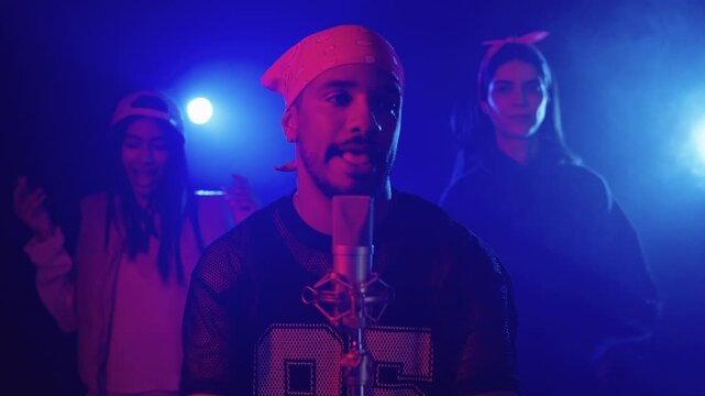 Singer performing live with backup dancers in slow motion