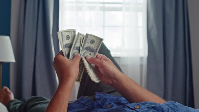 Secretive Male Figure Counts Bundles Of Cash In Dim Light, Reflecting Bribes, Financial Deception, Hidden Capital, Investment Scams, And Unreported Income Linked To Criminal Syndicates.