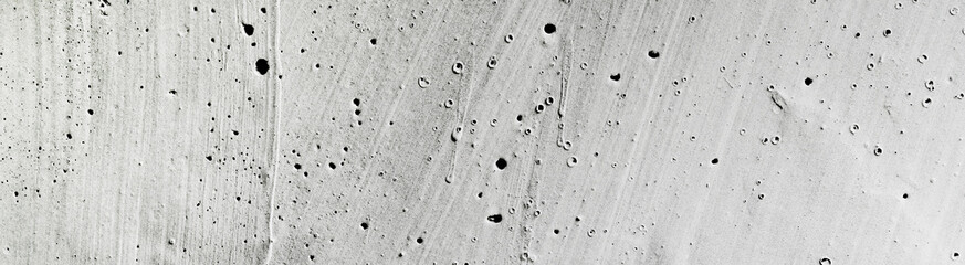 Close up of a gray concrete wall surface texture perfect for backgrounds, construction concepts, urban themes, and industrial design projects.
