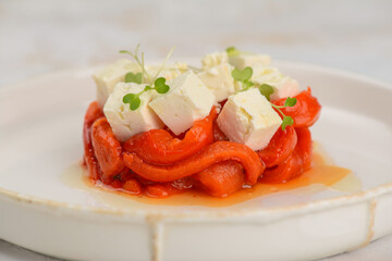 appetizer salad with paprika and cheese on a plate macro photo