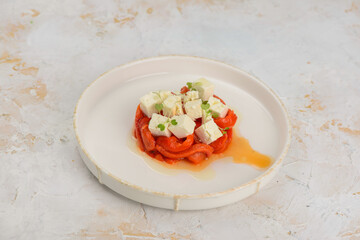 appetizer salad of paprika with cheese on a plate