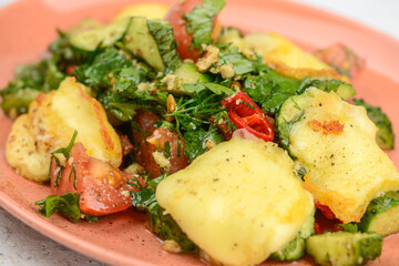 salad appetizer cucumbers tomatoes greens with fried cheese on a plate macro