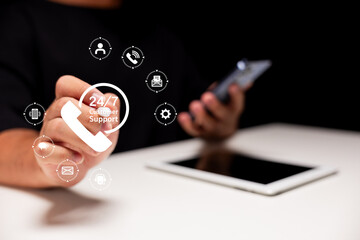 A hand gestures towards a digital interface displaying various customer support icons, symbolizing 24/7 assistance with technology.
