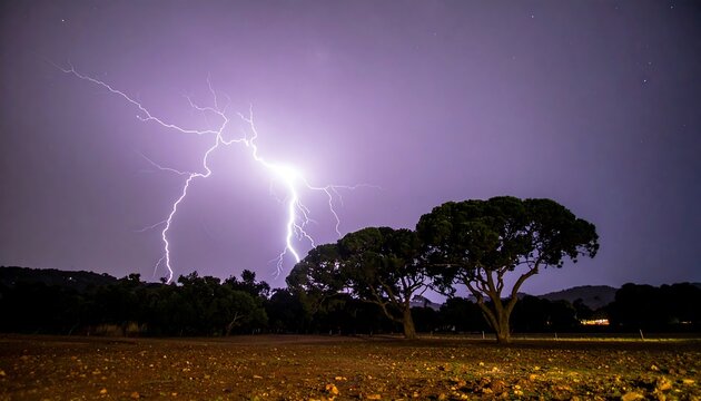 Powerful lightning illuminates a field of trees under a vibrant purple sky at night. - Powered by Adobe