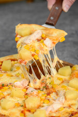 Hawaiian pizza with cucumber and pineapple with cheese on a stick
