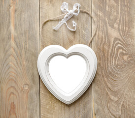 Heart shaped rustic white frame mockup with
transparent background on aged wooden surface
