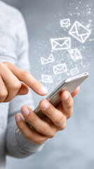 Close-up of a smartphone user working. Three-dimensional email symbols flying out of the screen. Concept of online communication, digital technology and instant messaging.
